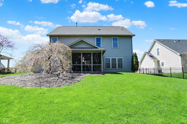 back of house with fence, a sunroom, and a lawn