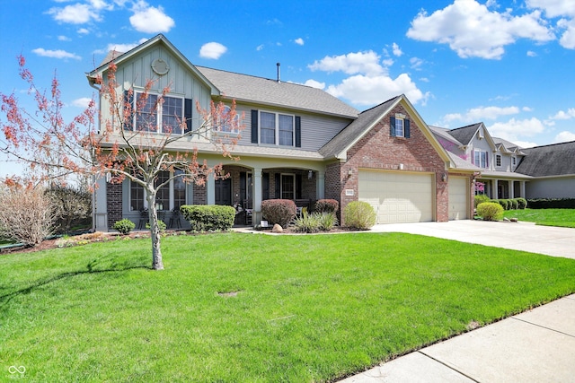 view of front of home featuring a garage, a front yard, brick siding, and driveway