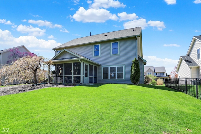back of house with a sunroom, fence, and a lawn