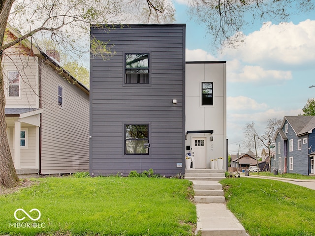 contemporary home with a residential view and a front yard