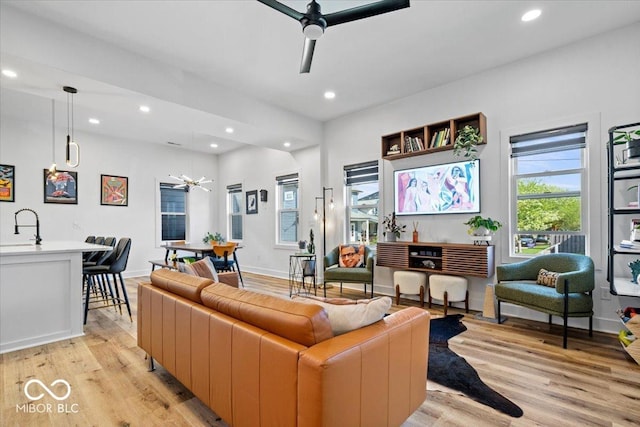 living room with recessed lighting, a ceiling fan, and light wood finished floors