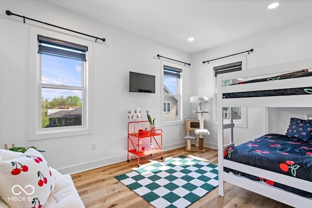 bedroom with baseboards, recessed lighting, and wood finished floors