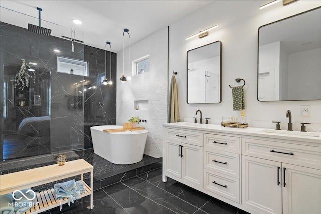 full bathroom with double vanity, a sink, a marble finish shower, and marble finish floor