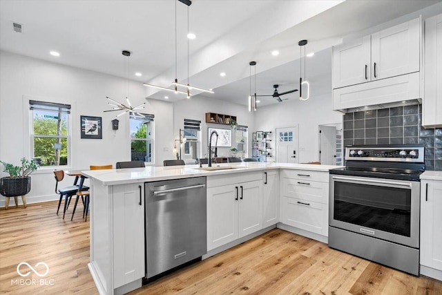 kitchen with visible vents, appliances with stainless steel finishes, a sink, light wood finished floors, and recessed lighting
