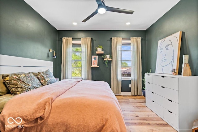 bedroom with light wood-style floors, a ceiling fan, and recessed lighting