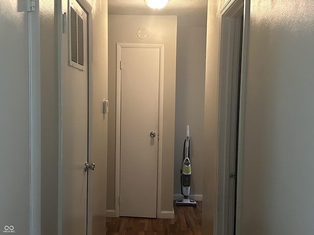 hall featuring a textured ceiling and wood finished floors