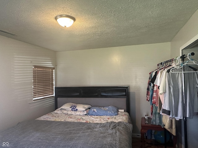 bedroom featuring visible vents and a textured ceiling