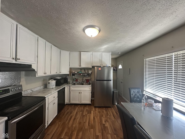 kitchen with under cabinet range hood, white cabinets, black appliances, and a sink
