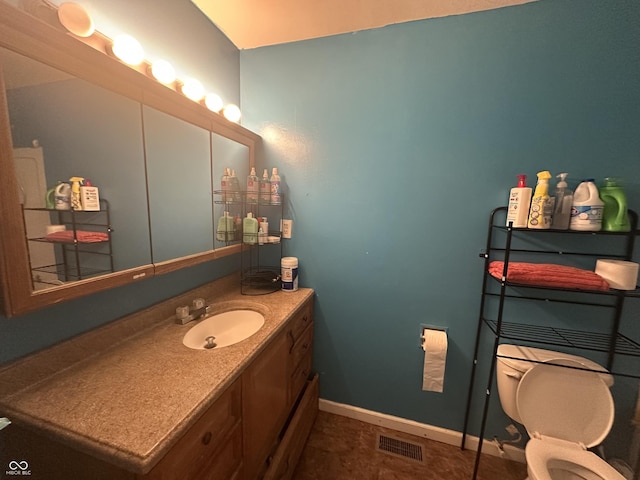 bathroom featuring visible vents, baseboards, toilet, and vanity