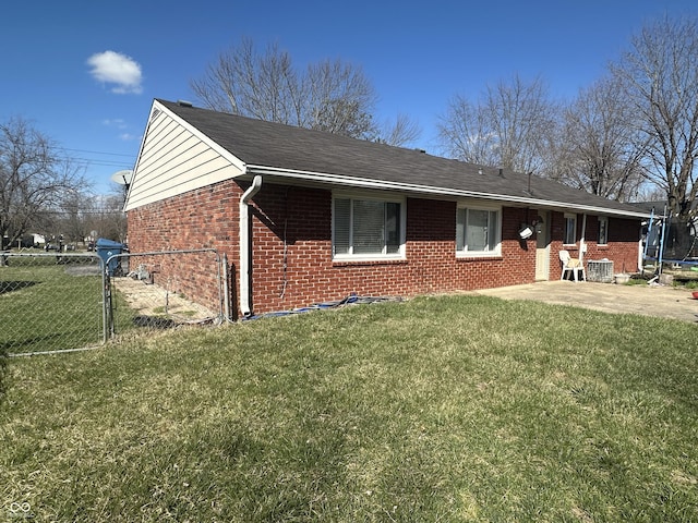 exterior space with central air condition unit, a lawn, a gate, a trampoline, and fence