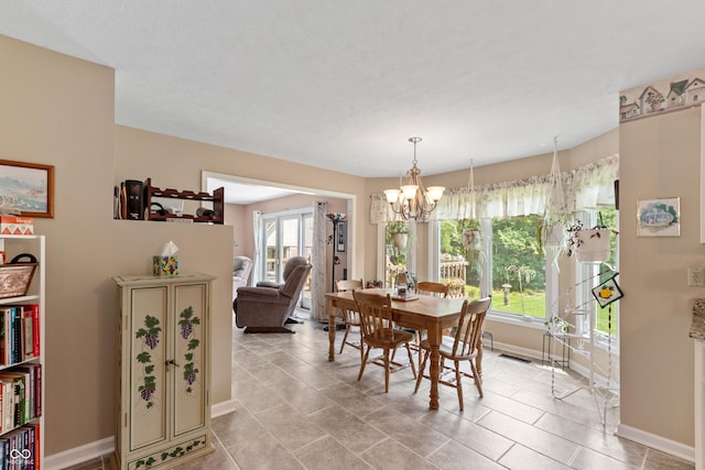 7341 Campfire Run, Indianapolis, IN 46236 - dining room with baseboards, a chandelier, and light tile patterned floors