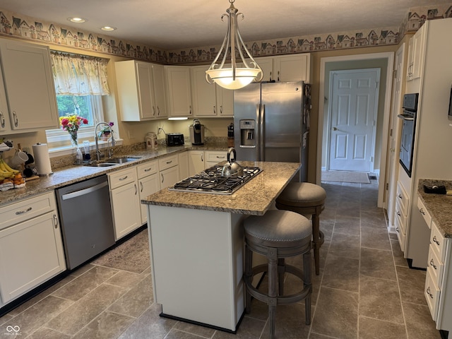 7341 Campfire Run, Indianapolis, IN 46236 - kitchen with appliances with stainless steel finishes, a sink, a kitchen bar, a center island, and light stone counters