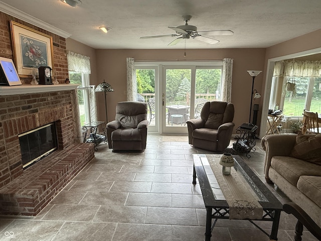 7341 Campfire Run, Indianapolis, IN 46236 - living room with plenty of natural light, ceiling fan, a brick fireplace, and a textured ceiling