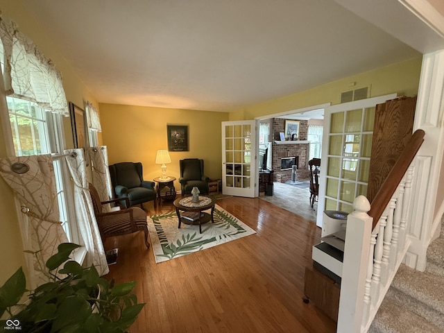 7341 Campfire Run, Indianapolis, IN 46236 - sitting room with wood finished floors, french doors, plenty of natural light, and a brick fireplace
