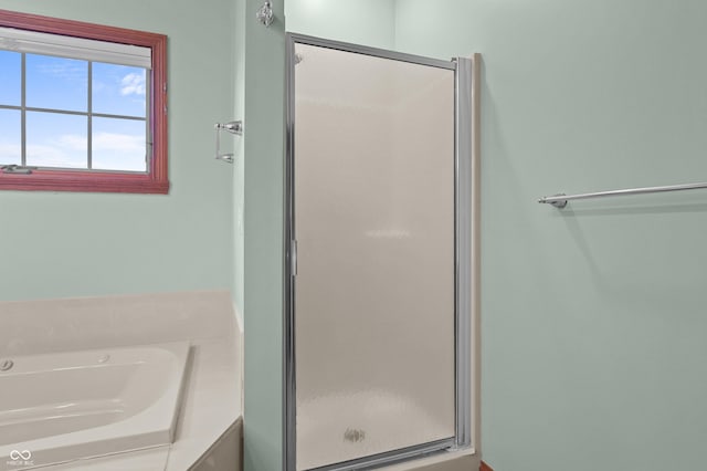 full bathroom with a shower stall and a garden tub