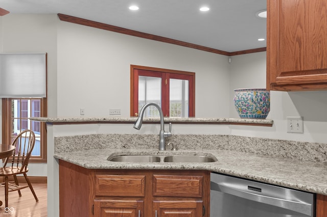 kitchen featuring ornamental molding, a sink, dishwasher, brown cabinets, and wood finished floors