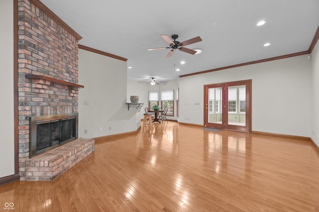 unfurnished living room featuring baseboards, ornamental molding, light wood-style floors, and a ceiling fan