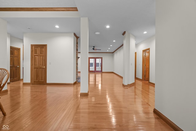 hallway with baseboards, light wood-type flooring, and recessed lighting