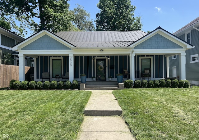 3535 Birchwood Ave, Indianapolis, IN 46205 - view of front facade with a porch, a standing seam roof, and board and batten siding