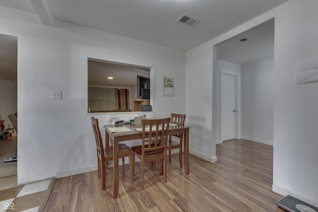5110 Chelsea Rd, Indianapolis, IN 46241 - dining room featuring baseboards, visible vents, and wood finished floors