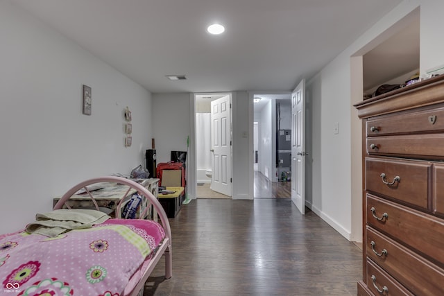 5110 Chelsea Rd, Indianapolis, IN 46241 - bedroom with connected bathroom, dark wood-style floors, visible vents, and baseboards