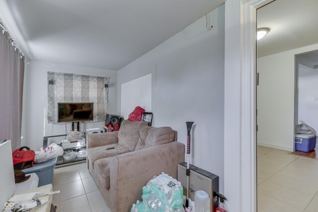 5110 Chelsea Rd, Indianapolis, IN 46241 - living area with light tile patterned flooring and a fireplace