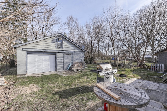 5110 Chelsea Rd, Indianapolis, IN 46241 - view of yard featuring fence, driveway, a detached garage, and an outdoor structure