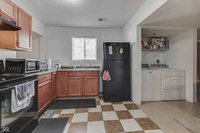 5110 Chelsea Rd, Indianapolis, IN 46241 - kitchen featuring range, visible vents, under cabinet range hood, washer and clothes dryer, and freestanding refrigerator
