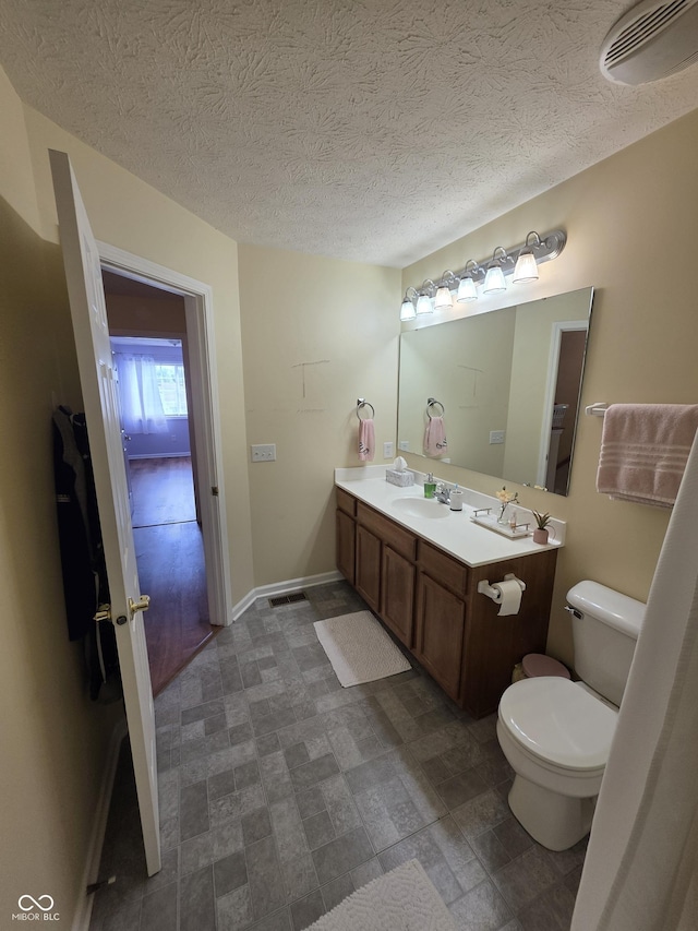 8160 Shores Edge Way, Indianapolis, IN 46237 - bathroom with toilet, vanity, baseboards, and a textured ceiling