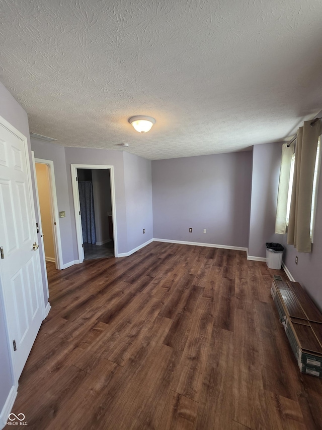 8160 Shores Edge Way, Indianapolis, IN 46237 - spare room featuring dark wood-style flooring, a textured ceiling, baseboards, and baseboard heating