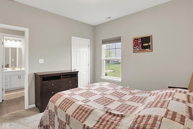 15752 Matthews Ln, Noblesville, IN 46060 - bedroom featuring light colored carpet, visible vents, a sink, and ensuite bath