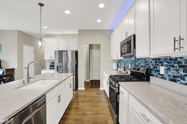 15752 Matthews Ln, Noblesville, IN 46060 - kitchen with pendant lighting, dark wood-style flooring, white cabinets, a sink, and stainless steel appliances