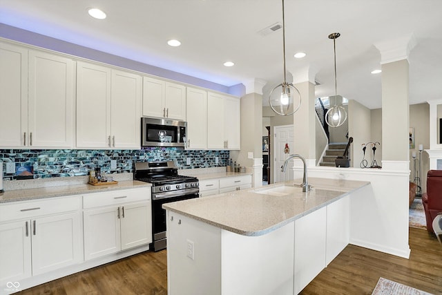 15752 Matthews Ln, Noblesville, IN 46060 - kitchen with a sink, backsplash, white cabinets, and stainless steel appliances