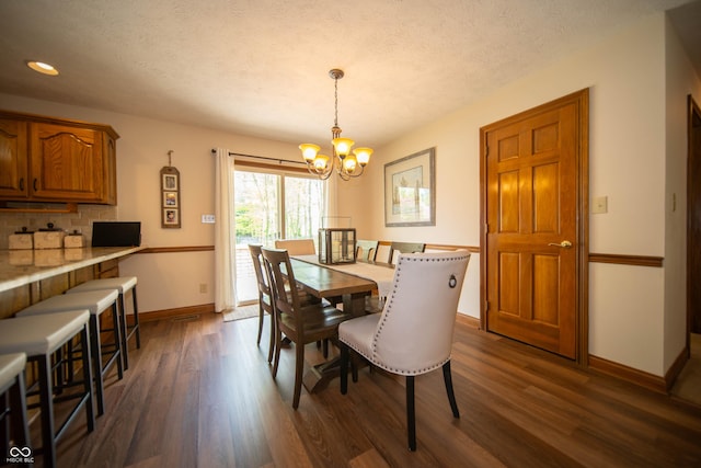 7732 Ashtree Dr, Indianapolis, IN 46259 - dining space with a textured ceiling, baseboards, recessed lighting, dark wood finished floors, and a notable chandelier