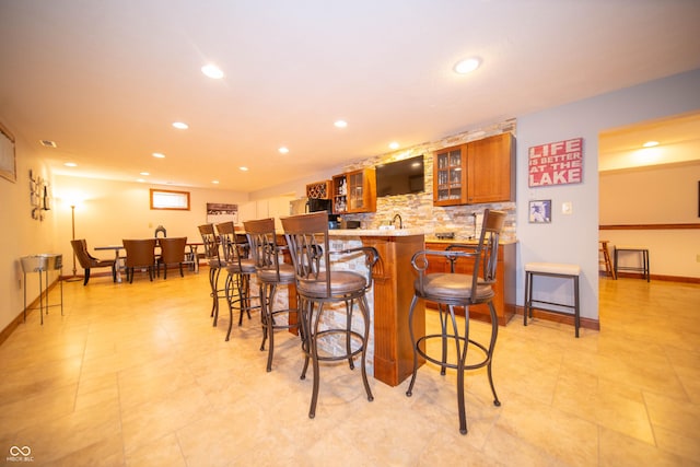 7732 Ashtree Dr, Indianapolis, IN 46259 - bar featuring tasteful backsplash, baseboards, indoor wet bar, and recessed lighting