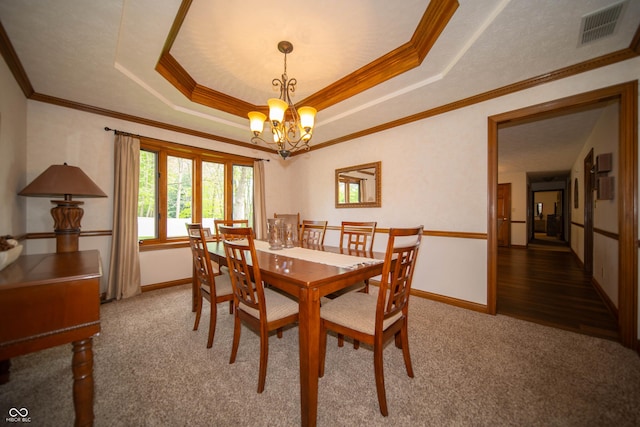 7732 Ashtree Dr, Indianapolis, IN 46259 - carpeted dining area with a tray ceiling, ornamental molding, an inviting chandelier, and visible vents