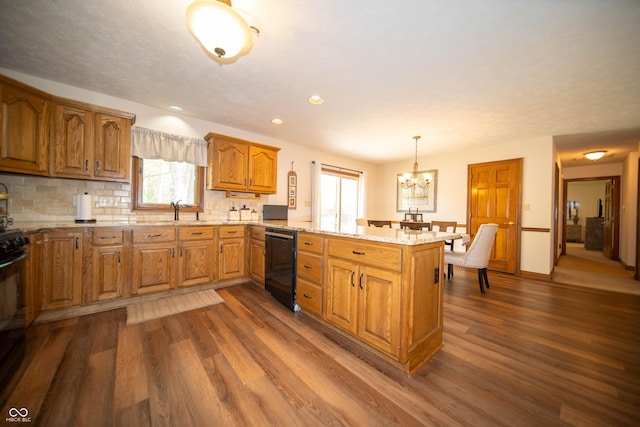 7732 Ashtree Dr, Indianapolis, IN 46259 - kitchen featuring a peninsula, tasteful backsplash, brown cabinets, dark wood-style floors, and a notable chandelier