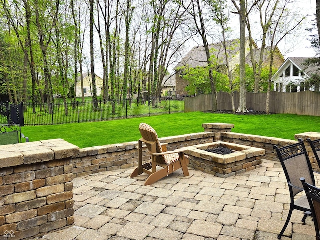 7732 Ashtree Dr, Indianapolis, IN 46259 - view of patio featuring a fire pit and a fenced backyard