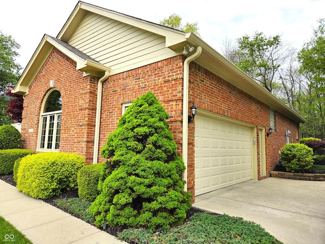 7732 Ashtree Dr, Indianapolis, IN 46259 - view of home's exterior featuring concrete driveway, brick siding, and an attached garage