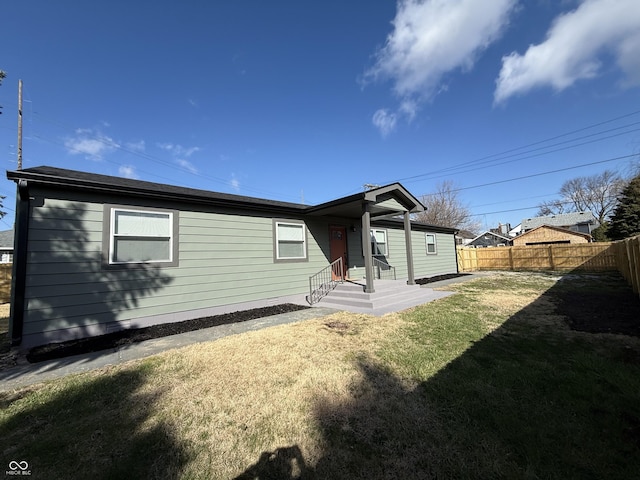 240 E Caven St E, Indianapolis, IN 46225 - rear view of property with a lawn and fence