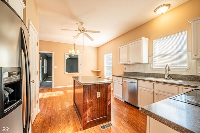11229 Echo Ridge Ln, Indianapolis, IN 46236 - kitchen featuring stainless steel appliances, light wood-style flooring, ceiling fan, and dark countertops