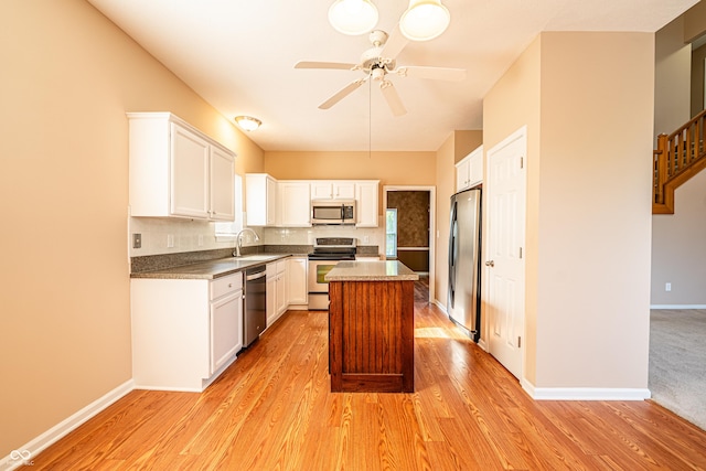 11229 Echo Ridge Ln, Indianapolis, IN 46236 - kitchen with appliances with stainless steel finishes, light wood finished floors, ceiling fan, white cabinetry, and a center island