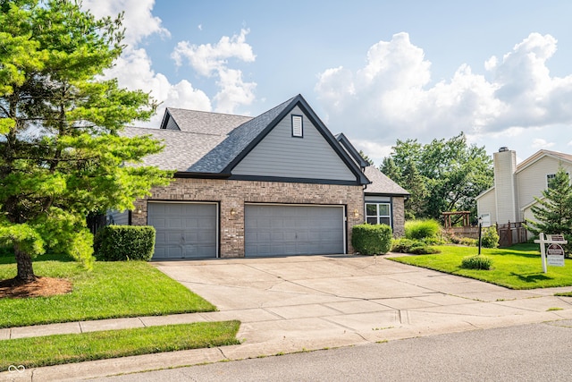 11229 Echo Ridge Ln, Indianapolis, IN 46236 - view of front of home with a front lawn, concrete driveway, brick siding, a shingled roof, and a garage