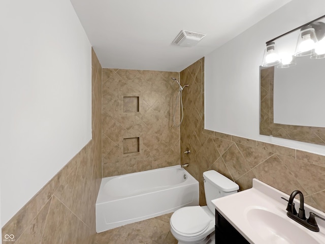 2928 Sheffield Dr, Indianapolis, IN 46229 - bathroom featuring tile walls, toilet, bathtub / shower combination, and vanity