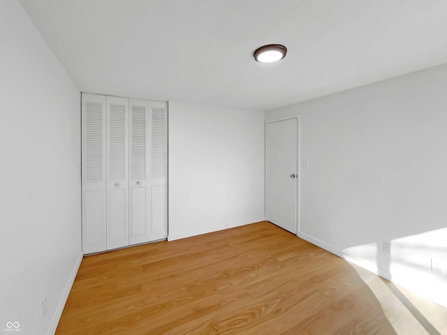 2928 Sheffield Dr, Indianapolis, IN 46229 - unfurnished bedroom featuring light wood-style flooring, a closet, and baseboards