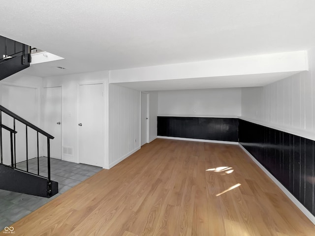 2928 Sheffield Dr, Indianapolis, IN 46229 - basement with wood finished floors, stairway, and baseboards
