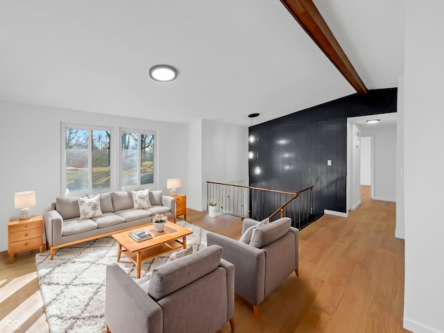 2928 Sheffield Dr, Indianapolis, IN 46229 - living area with light wood finished floors, an accent wall, beamed ceiling, and baseboards