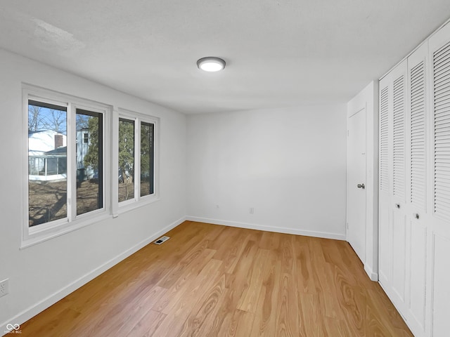 2928 Sheffield Dr, Indianapolis, IN 46229 - unfurnished bedroom featuring light wood finished floors, baseboards, and a closet