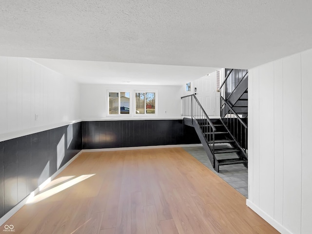 2928 Sheffield Dr, Indianapolis, IN 46229 - unfurnished room with wood finished floors, a textured ceiling, and stairway