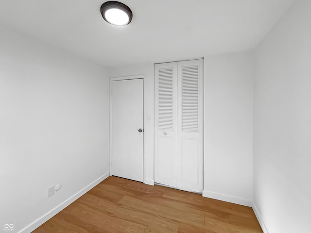 2928 Sheffield Dr, Indianapolis, IN 46229 - unfurnished bedroom featuring light wood-style flooring, baseboards, and a closet